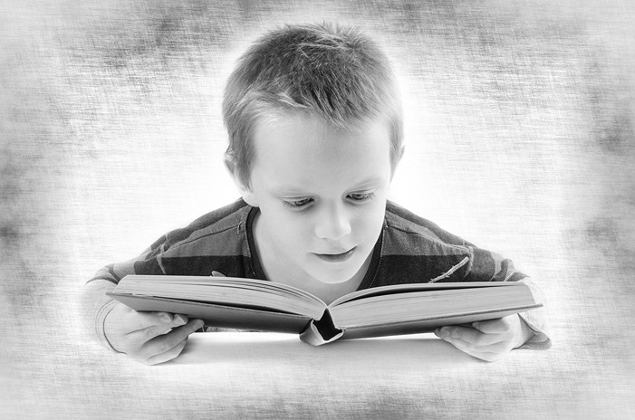 Partially sighted child reading